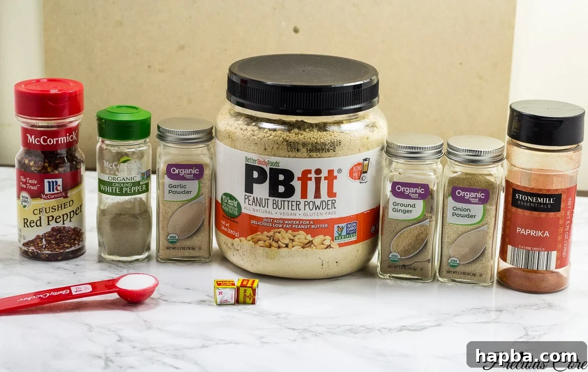 Key ingredients for homemade suya spice, including roasted peanuts, ginger, and peppers.