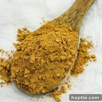 Suya spice on a wooden spoon, ready to be used in recipes.