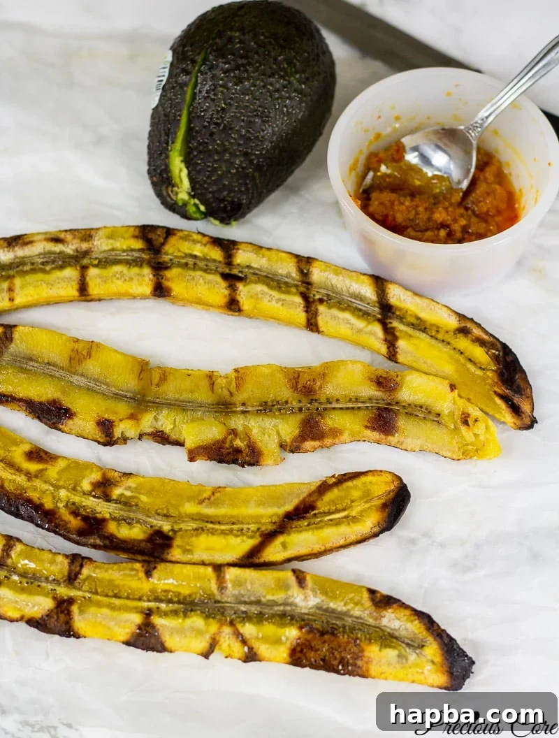 Perfectly Grilled Plantains 2 Halved plantains with grill marks.