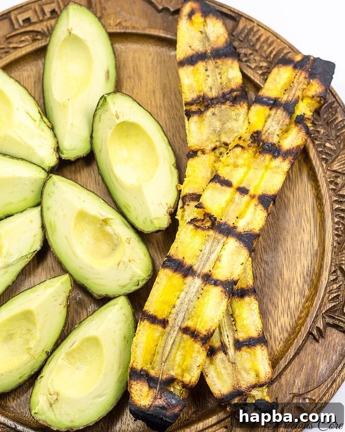 Perfectly Grilled Plantains 3 Plate with grilled plantains and avocado wedges.
