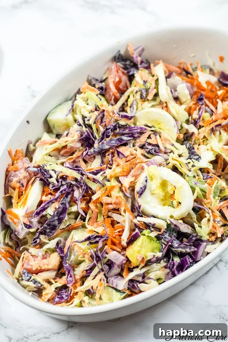 A stunning shot of the finished Cameroonian vegetable salad, showcasing its colorful layers and rich dressing, inviting you to dig in.