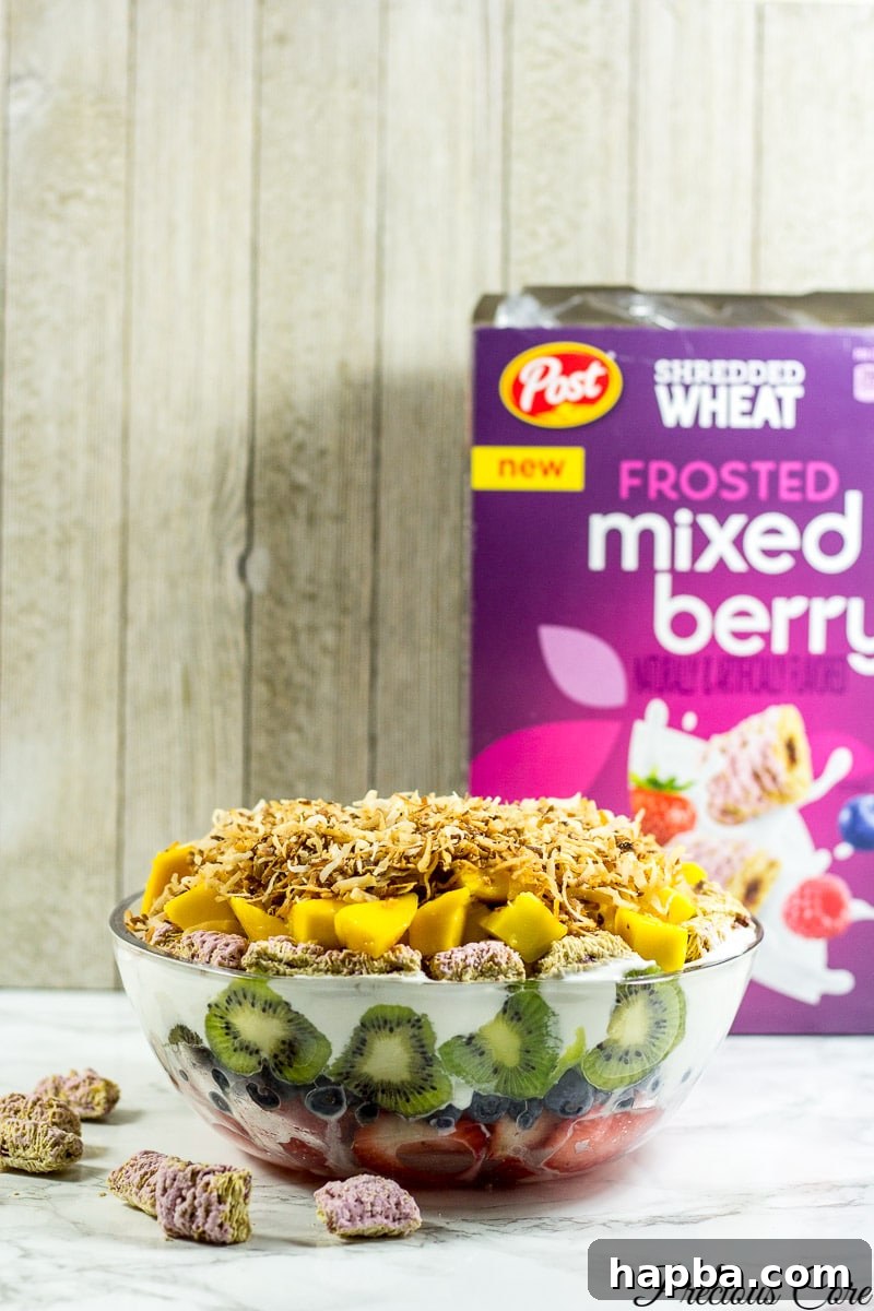 Seven layer fruit salad with a box of Frosted mixed berry Shredded Wheat.