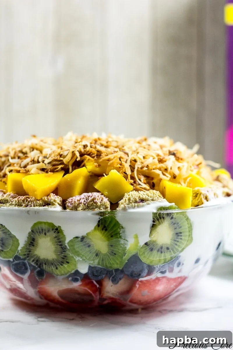 Seven layer fruit salad in a glass bowl.