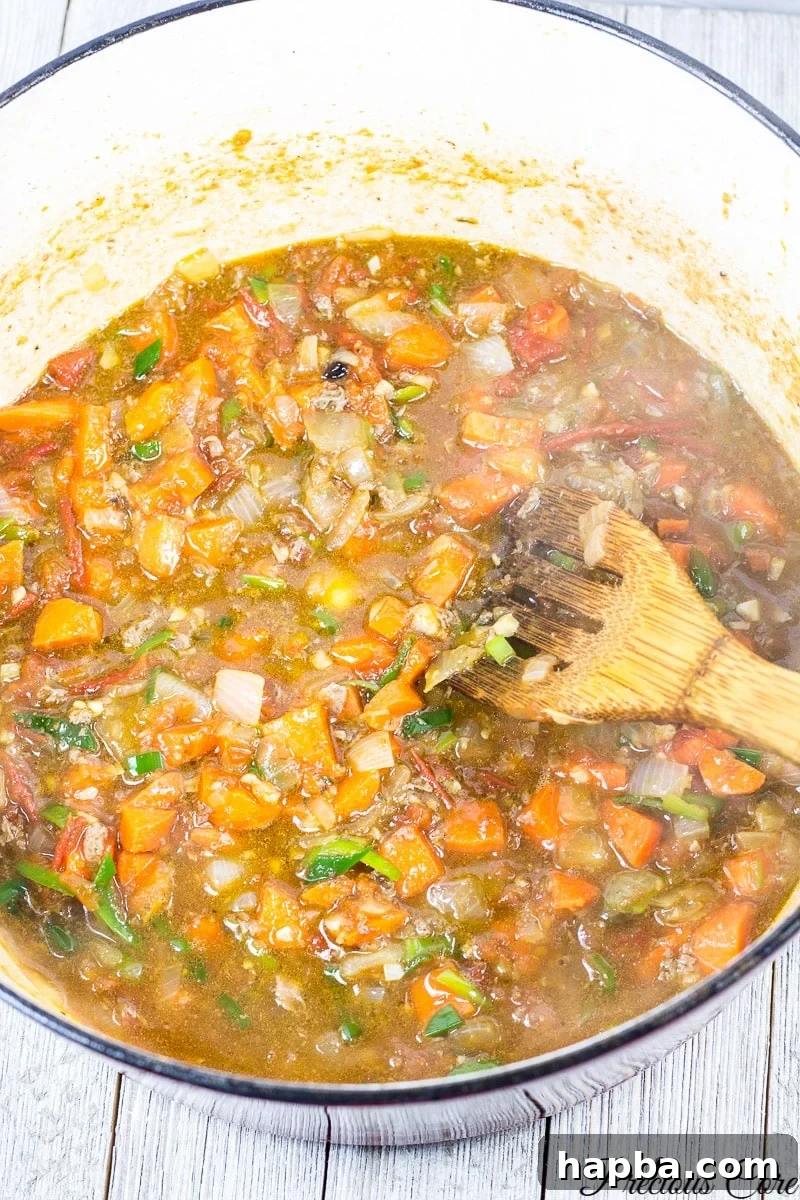 Wholesome White Bean Pot 4 Rich tomato and onion stew base simmering in a pot.