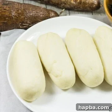 Water fufu or cassava fufu on a white plate.