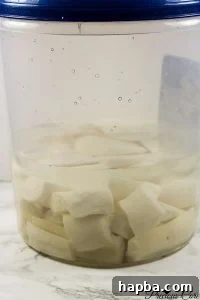 Fermenting cassava roots soaking in water, an essential step for preparing homemade Water Fufu.