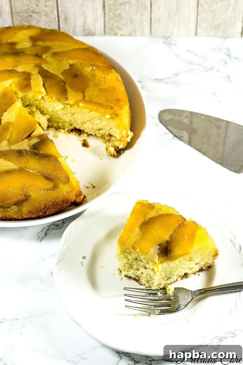 Tropical Mango Delight Cake 9 A close-up of a slice of mango upside down cake, showcasing the luscious fruit and moist cake texture