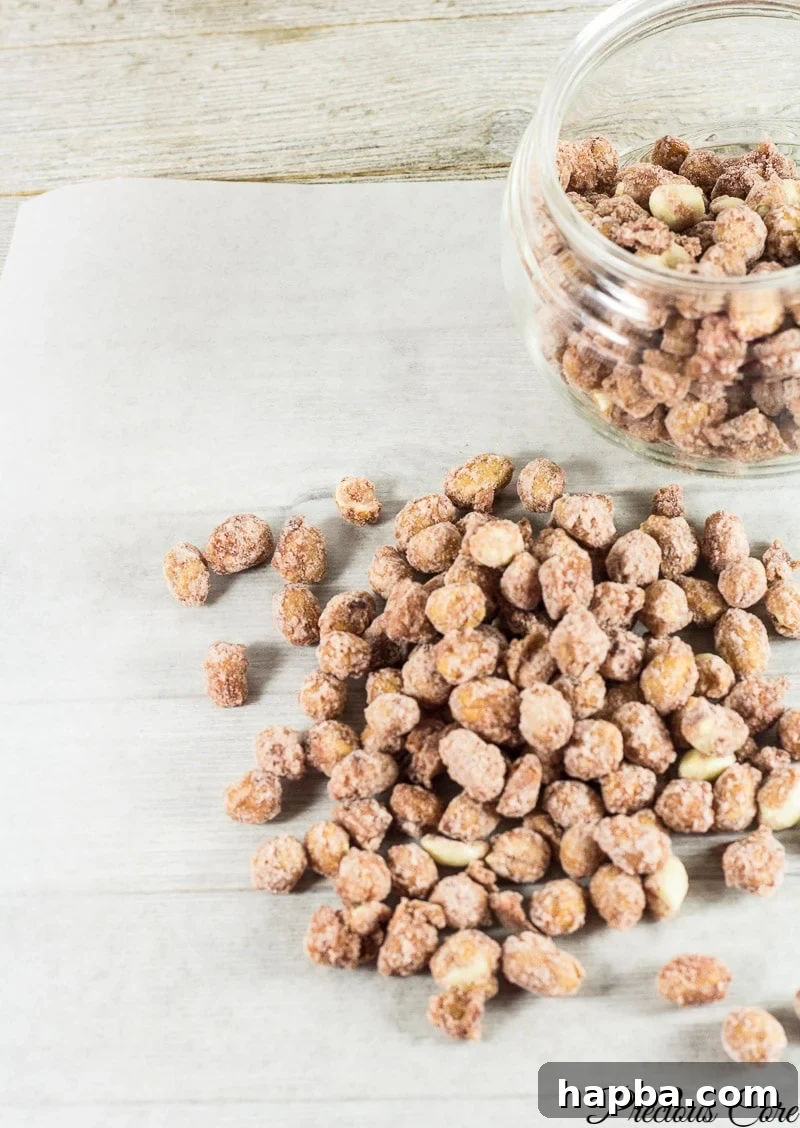 Candied nuts in and around a glass jar.