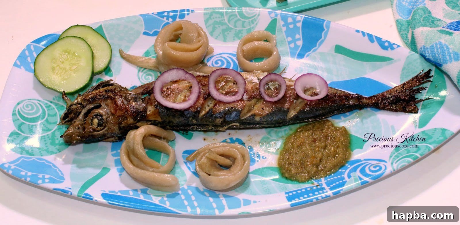 Preparing Cameroonian Roasted Fish on a grill