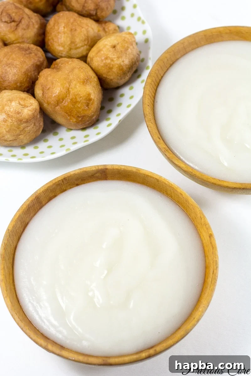A serving of smooth, creamy pap in a traditional bowl, garnished with a sprinkle of sugar, reflecting a comforting and simple meal.