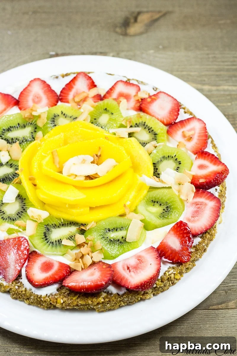 Breakfast pizza topped with strawberries, kiwi, and more.