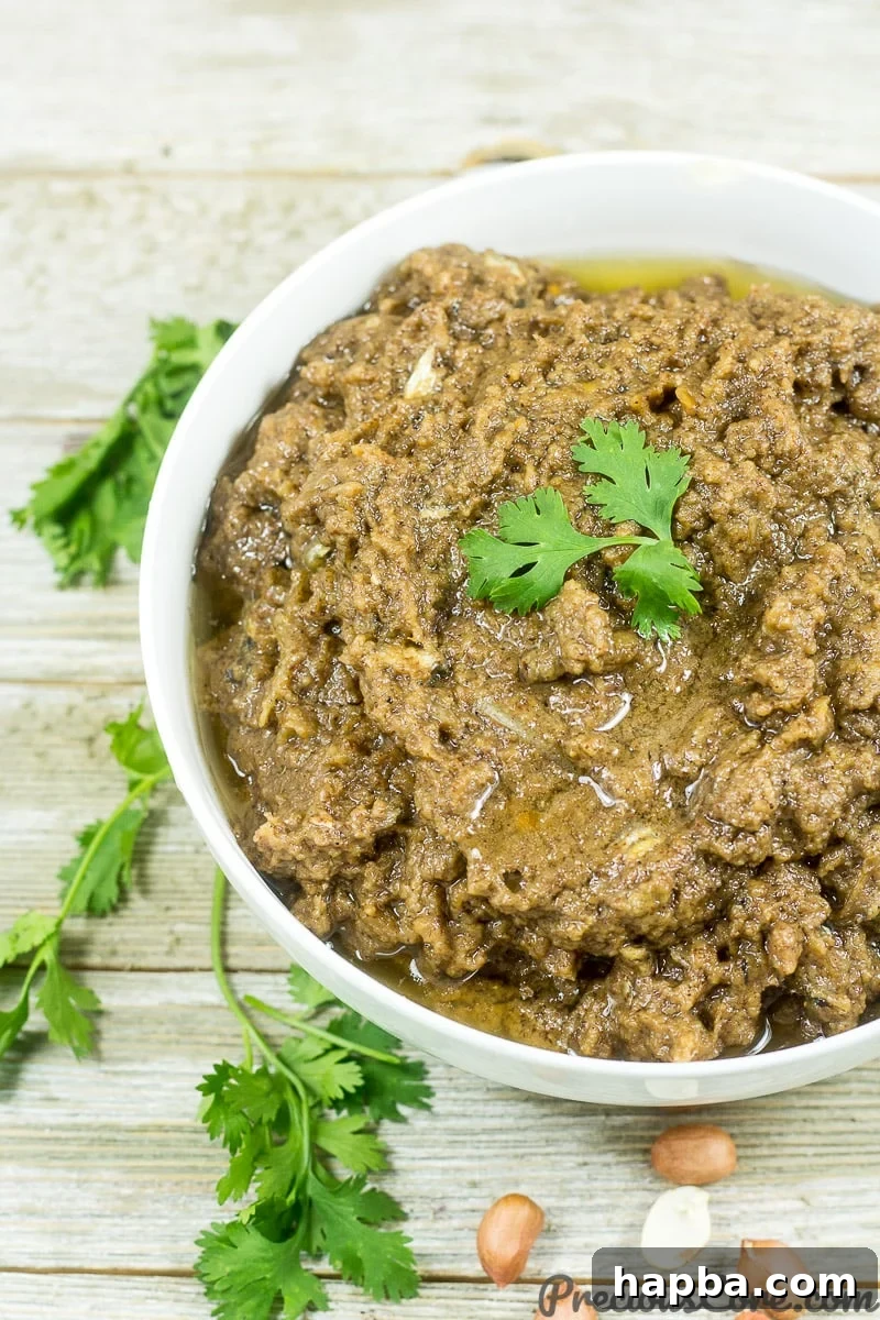 A close-up shot of the savory Cameroonian Mboh, highlighting its smooth texture and rich, nutty appearance in a serving bowl.