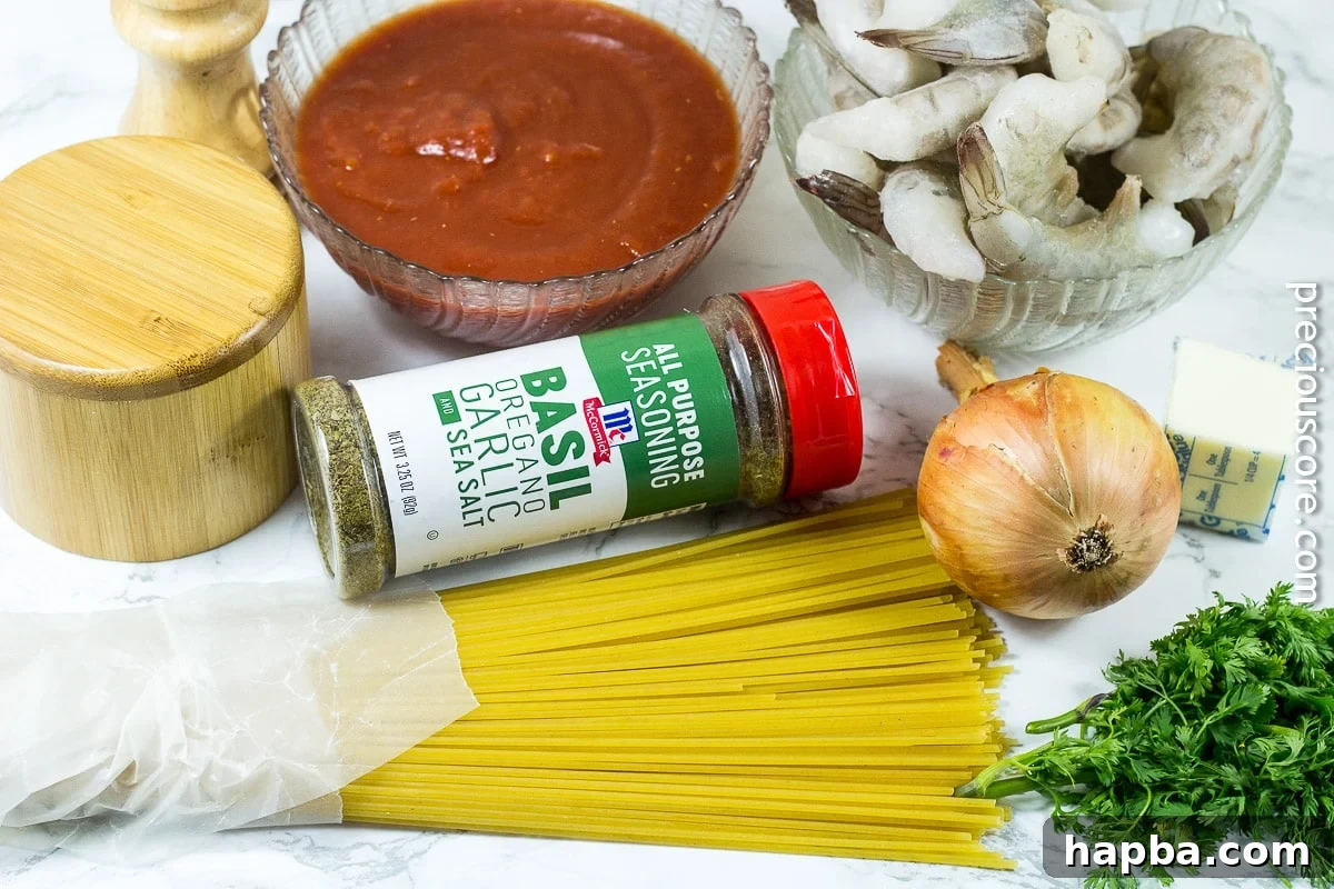 Collection of fresh ingredients for blackened shrimp pasta, including shrimp, pasta, tomatoes, and McCormick seasoning.