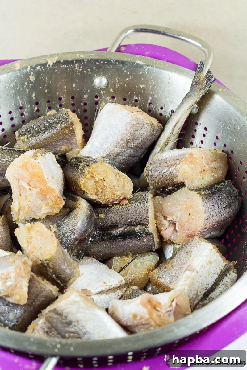 Sweet Heat Fish 3 Slices of fresh white fish, thoroughly seasoned with a blend of garlic, ginger, and onion powder, ready for frying as part of the Nigerian Peppered Fish recipe.