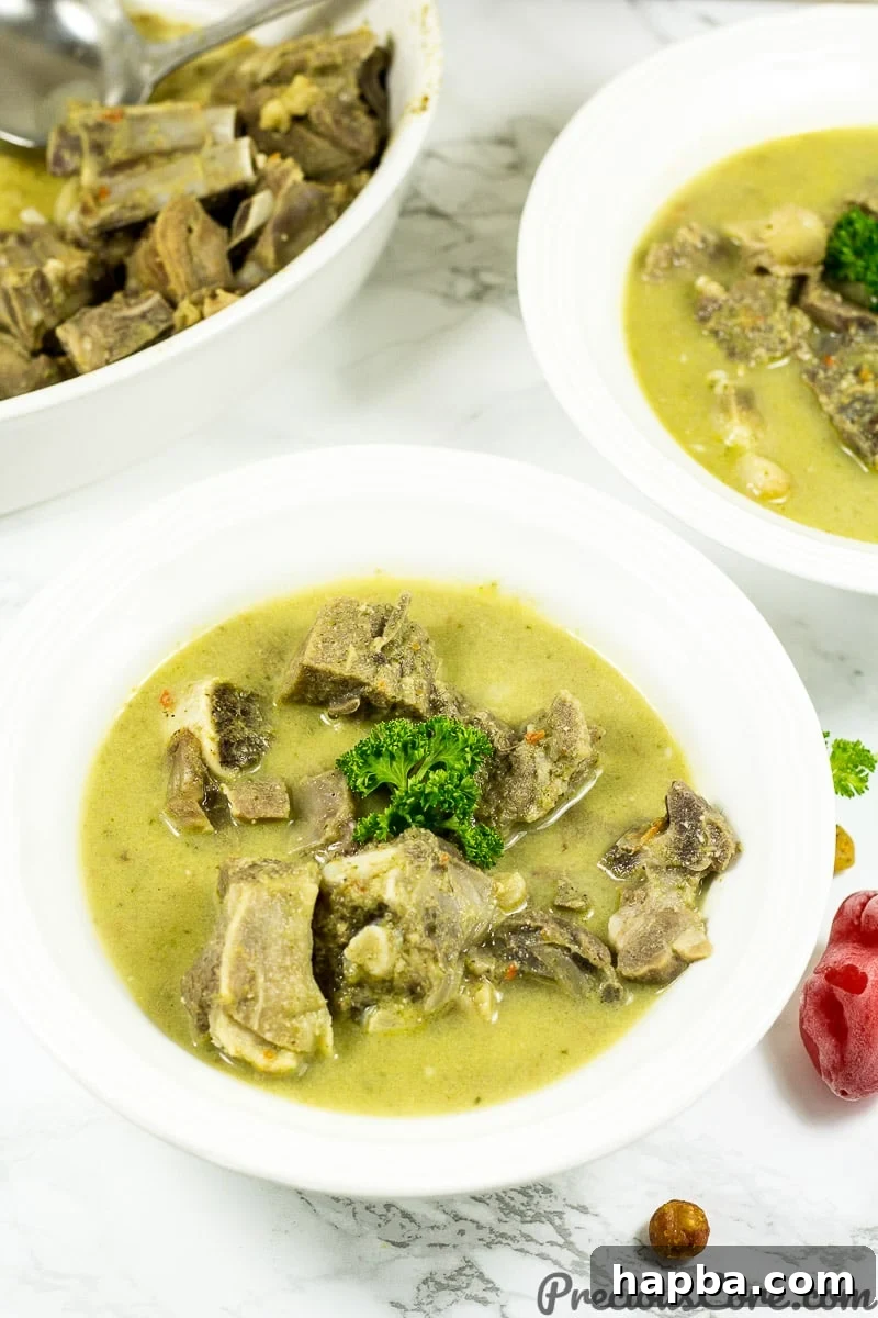 Close-up of Cameroonian style Goat Meat Pepper Soup with vibrant broth.