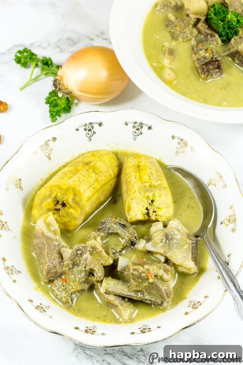Goat Meat Pepper Soup served alongside slices of boiled plantain.