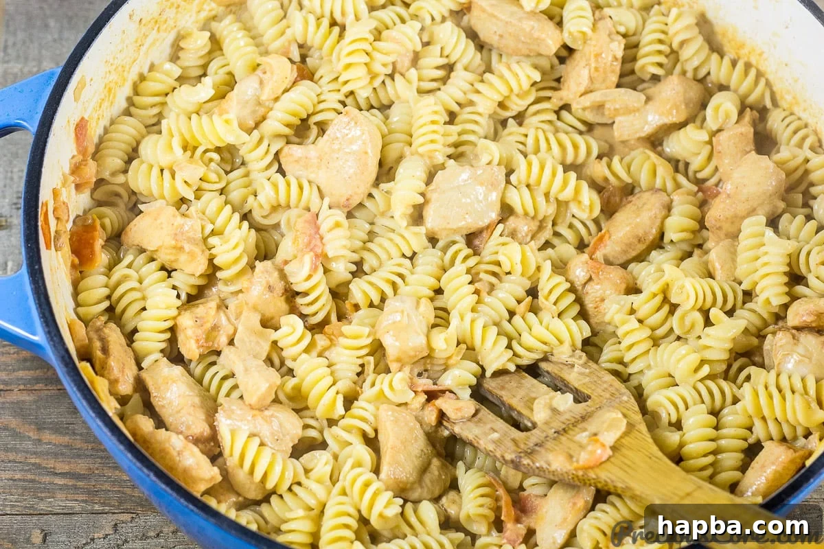 Stir Macaroni and Chicken to Combine Flavors