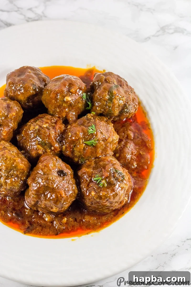 Rich African Meatballs simmering in a vibrant tomato sauce, perfect for a hearty dinner.