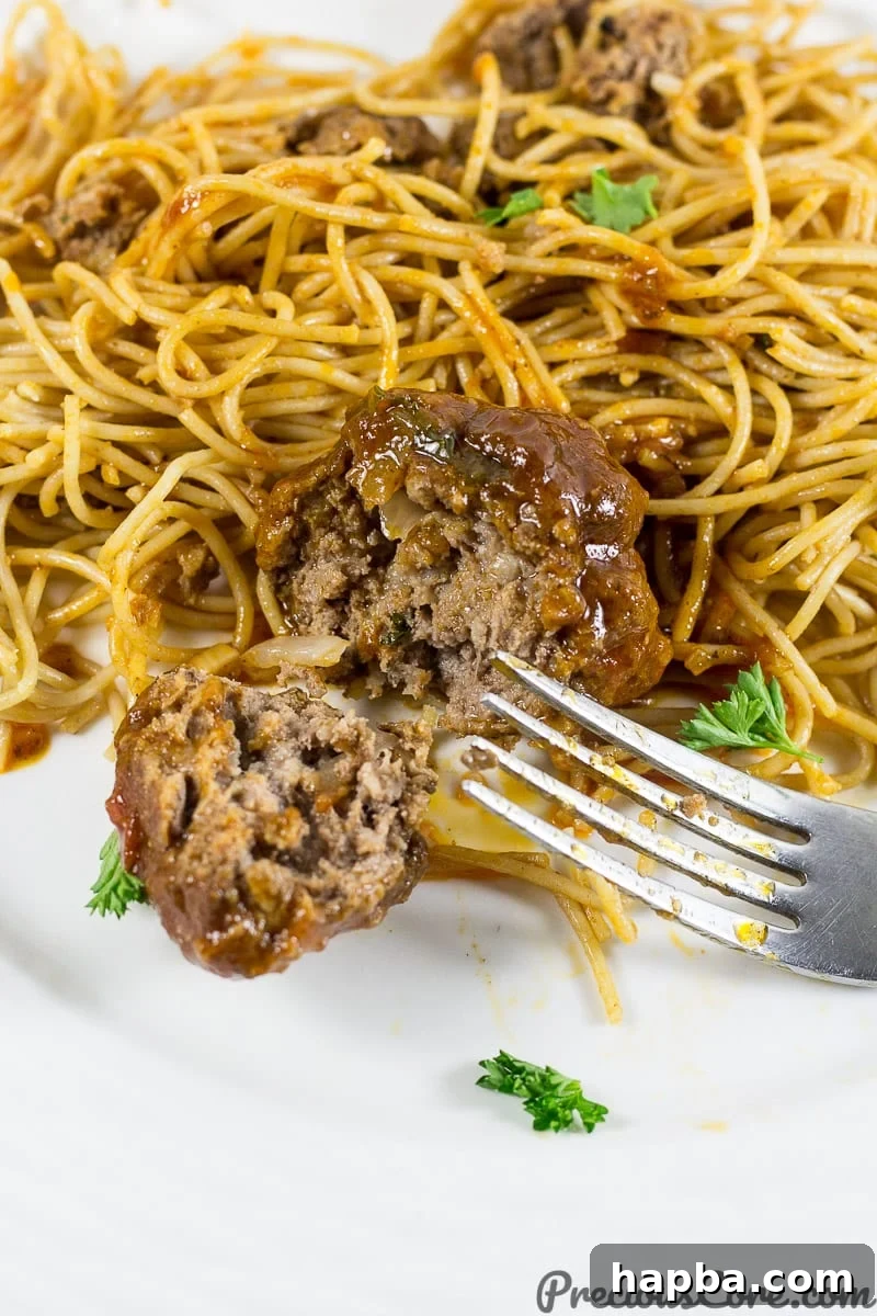 Platter of African meatballs served alongside spaghetti, a classic pairing for a delicious meal.