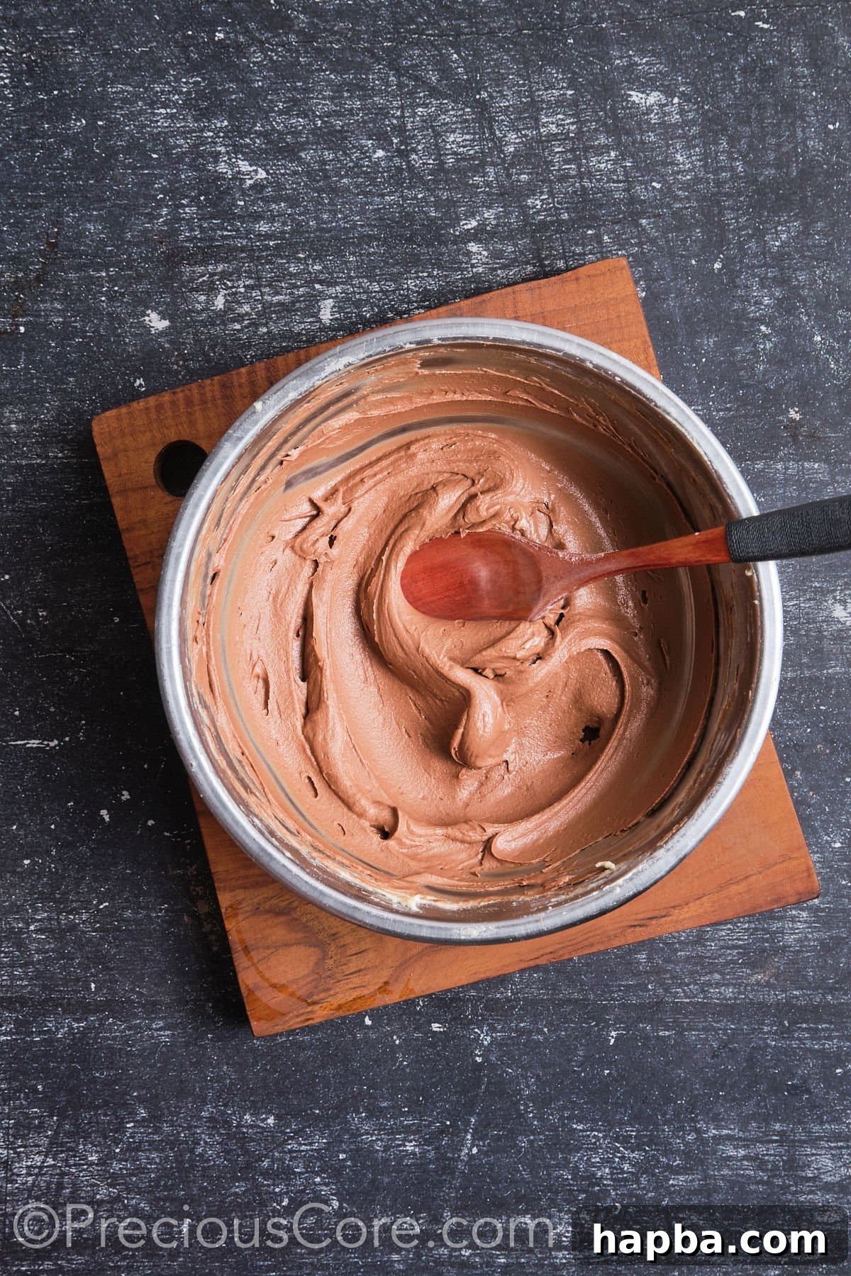 Rich, whipped chocolate frosting in a bowl, perfectly smooth and ready to use.