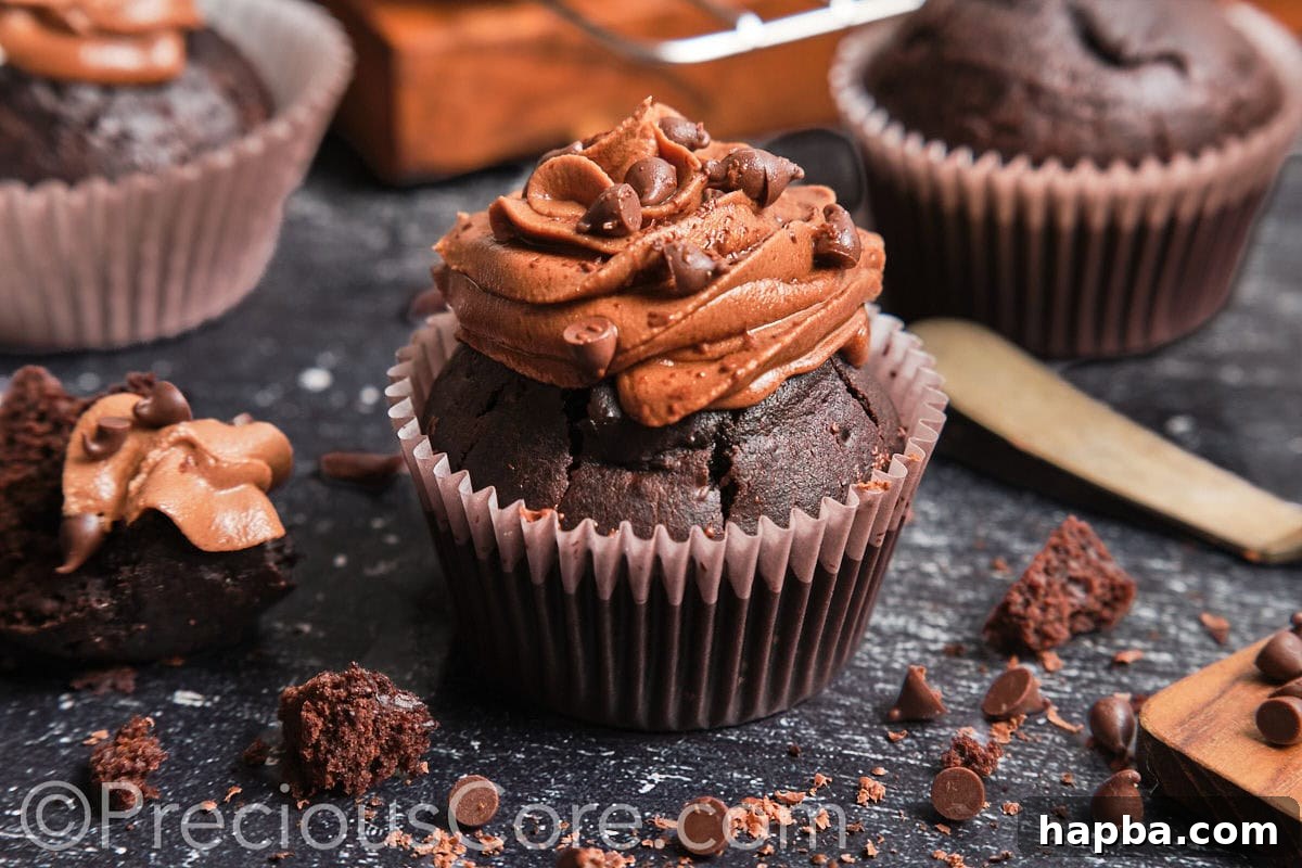 Landscape image of a beautifully frosted moist chocolate cupcake, ready to be enjoyed.