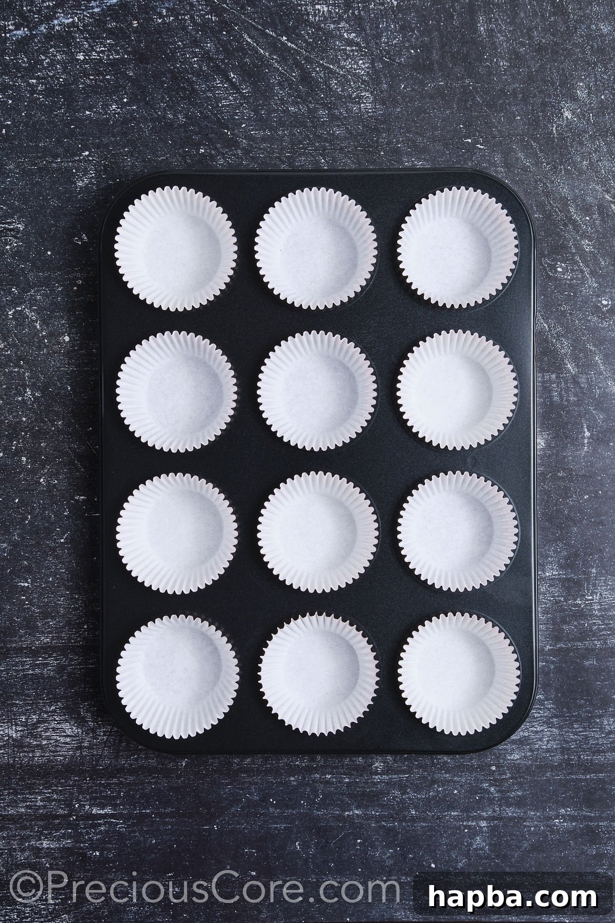 A muffin pan fully lined with cupcake liners, showing preparation for baking.