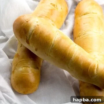 Three golden loaves of homemade milk bread, soft and ready to eat.