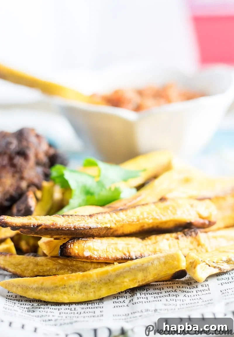 Golden Plantain Fries 5 Close-up shot of perfectly baked fries made from semi-ripe plantains, showcasing their golden texture.