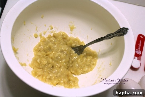 Mashing very ripe bananas in a bowl using a fork for pancake batter
