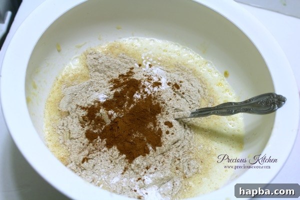 Dry ingredients including whole wheat flour, salt, baking powder, and cinnamon mixed in a bowl