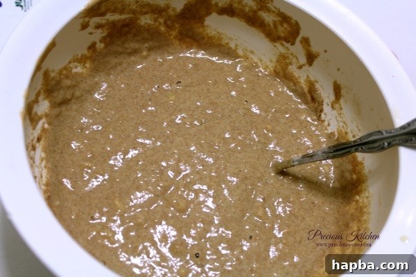 Pancake batter being mixed, showing the brown color from whole wheat flour and cinnamon