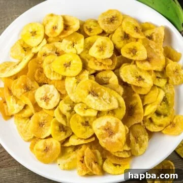 Plantain Chips on a white plate, perfectly crispy and golden.