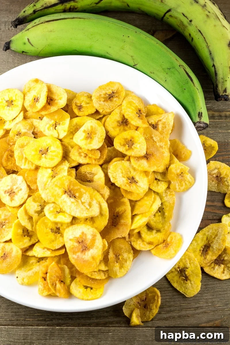 Homemade Plantain Chips on a white plate, ready to be served.