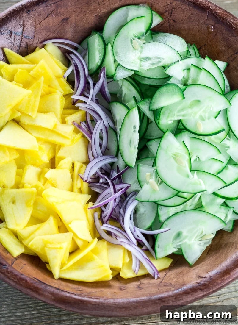 Sunshine Mango Cucumber Medley 3 Close-up of a bowl filled with colorful Cucumber Mango Salad.