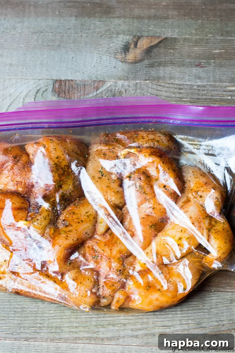 Succulent Grilled Chicken Strips 3 Chicken tenders marinating in a clear Ziploc bag, soaking up flavors