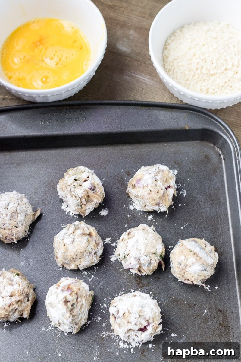 African Spiced Fish Balls 9 African Fish Balls shaped into uniform balls and lightly floured on a tray