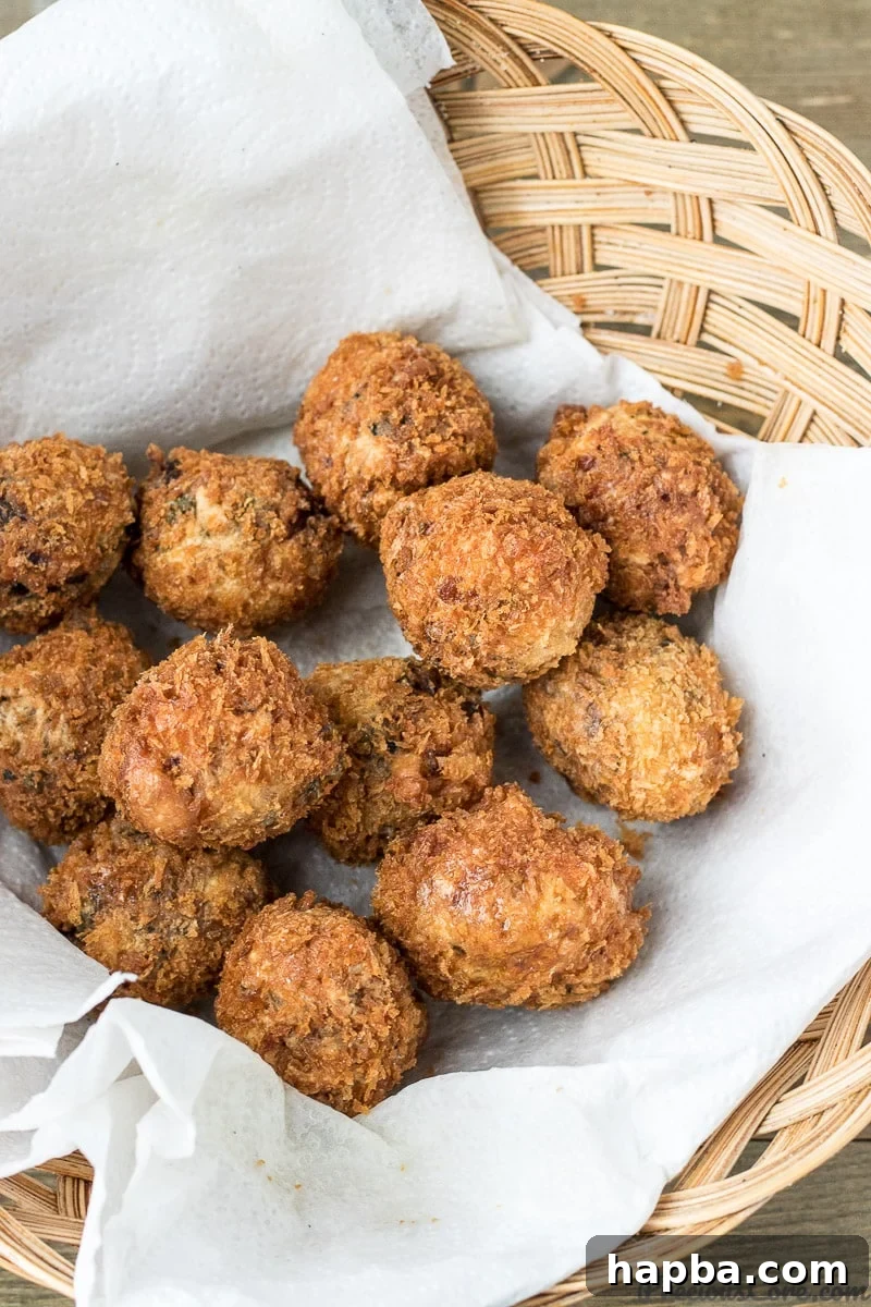 African Spiced Fish Balls 10 Freshly fried African Fish Balls, golden and crispy, resting on a plate
