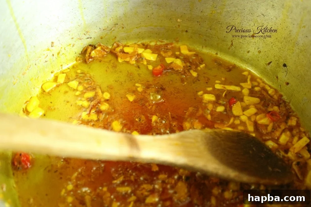 Ground crayfish, chili pepper, and a Maggi cube added to sautéed onions and palm oil, creating the rich flavor base for Tukuni.