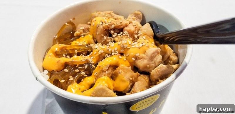 Delicious Korean takeout with glass noodles, chicken, and spicy mayo, a first-time culinary experience