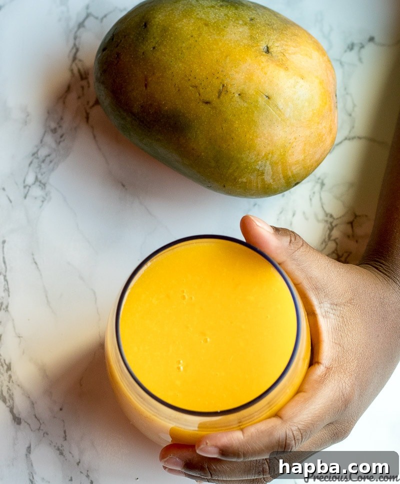 Several ripe, yellow mangoes arranged beautifully on a counter, signifying freshness and deliciousness.