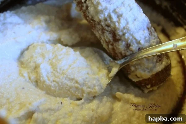 Scooping Accra beans batter into oil