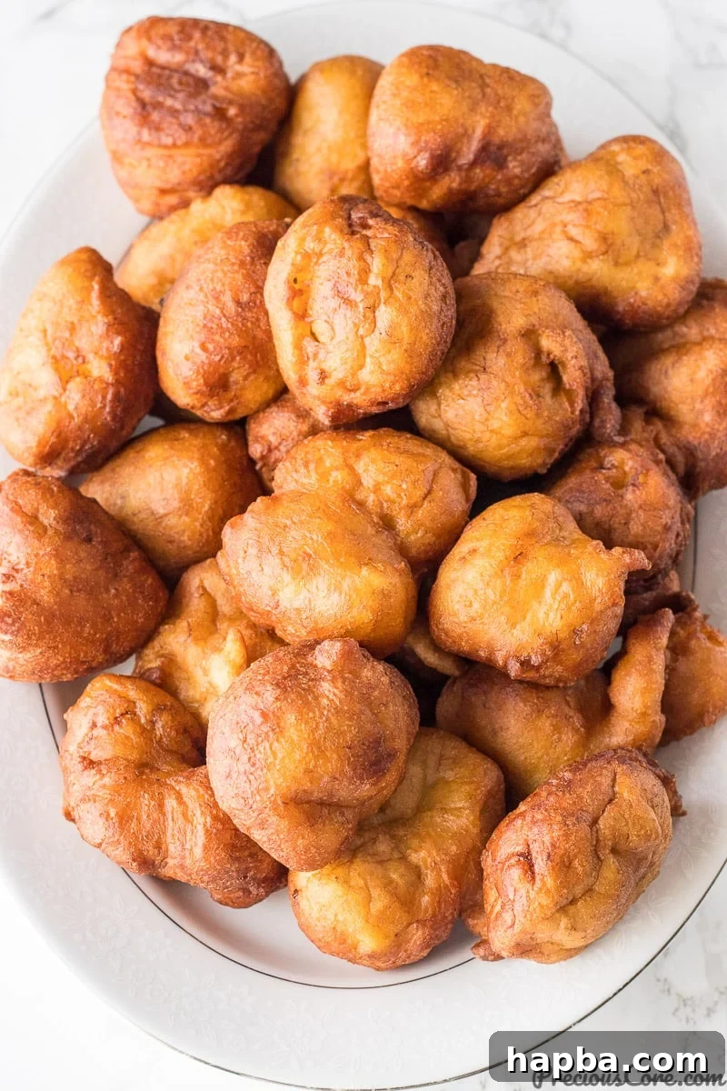 Golden Banana Bites 10 Brown fritters on a serving platter.