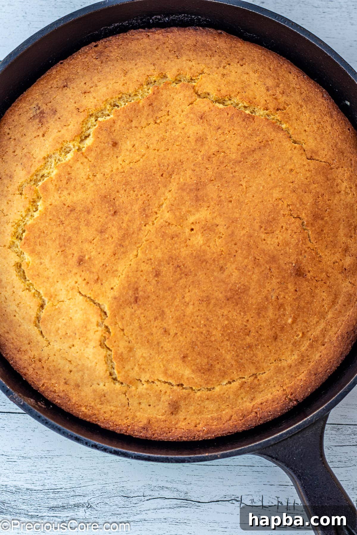 Moist Cornbread Without Buttermilk 9 Beautifully baked cornbread, golden brown and fluffy, cooling in a cast iron skillet.