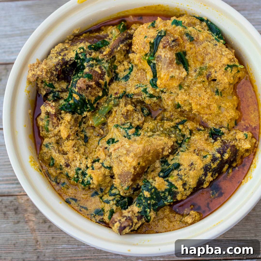 Melon Seed Magic 5 Nigerian Egusi Soup in a round white bowl, served hot.