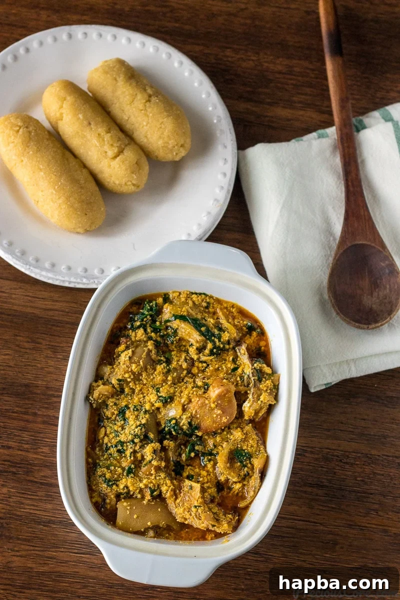 Melon Seed Magic 7 Melon seed Soup served with Garri (Eba) on a simple plate.