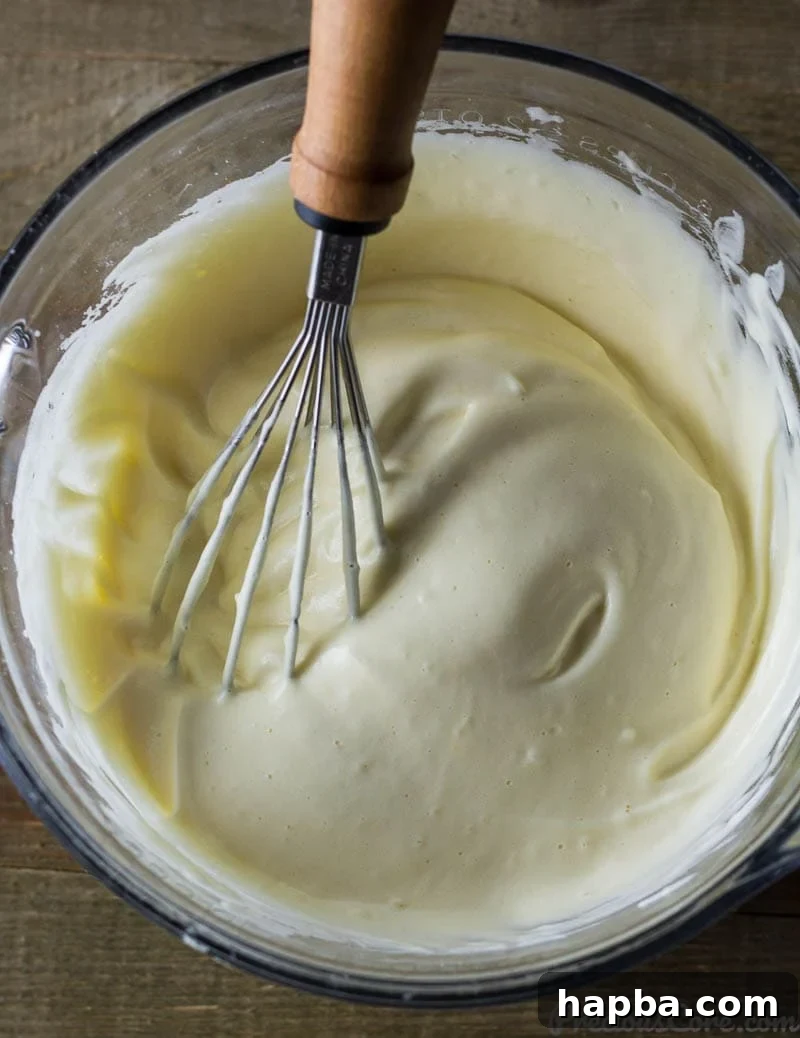 Golden Vanilla Dream 5 Whisk in a bowl with egg whites, vanilla, and egg yolks.