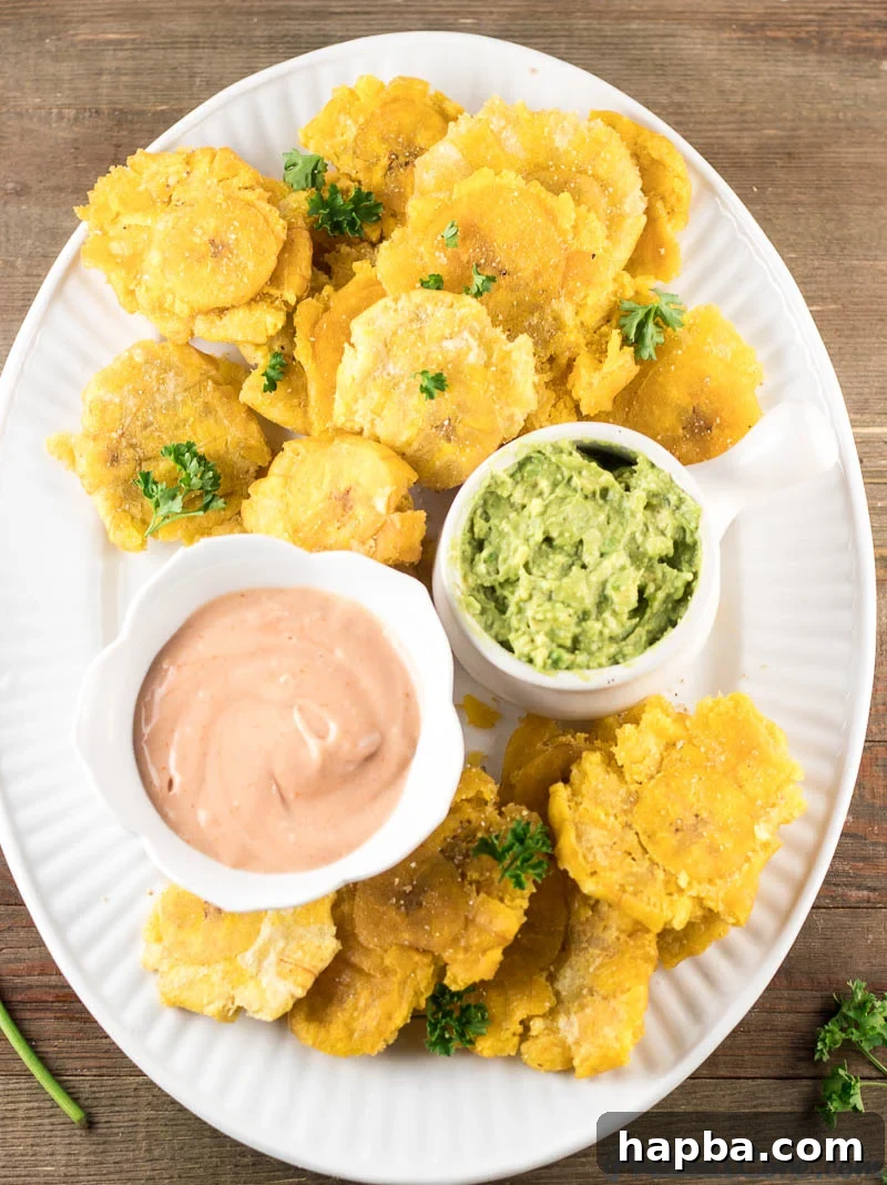 Crispy Tostones: Mastering the Twice-Fried Plantain 2 Tray of tostones with dips.