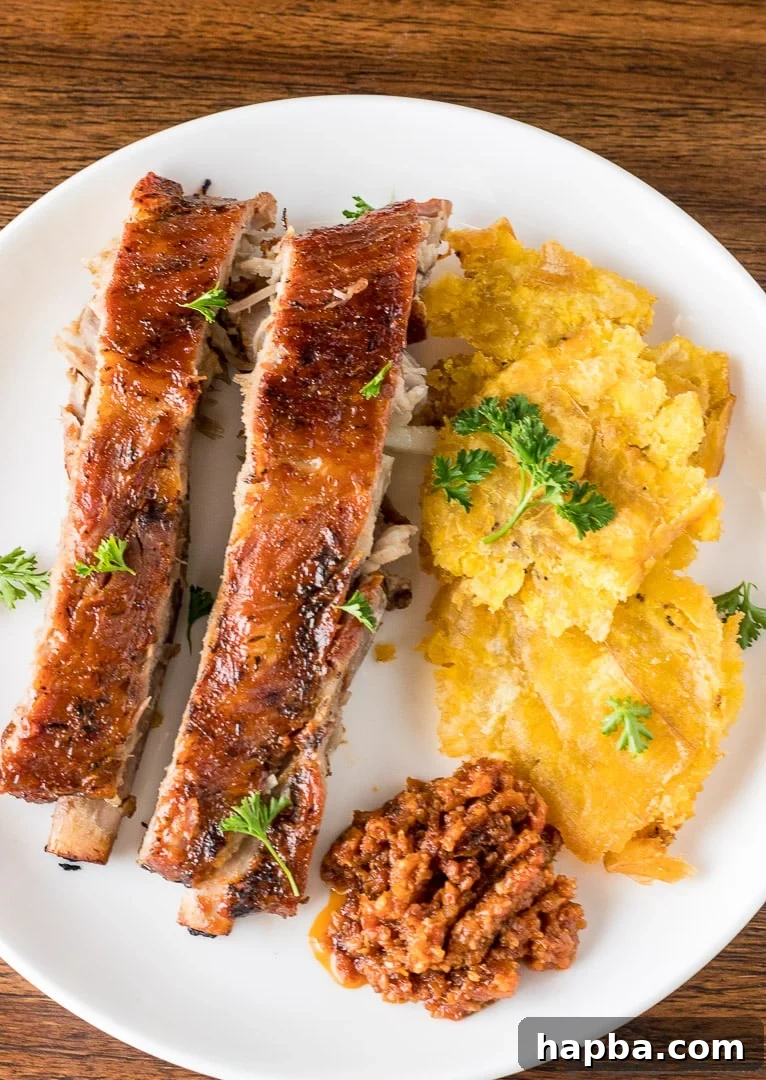 Crispy Tostones: Mastering the Twice-Fried Plantain 3 Tostones on a plate with meat.