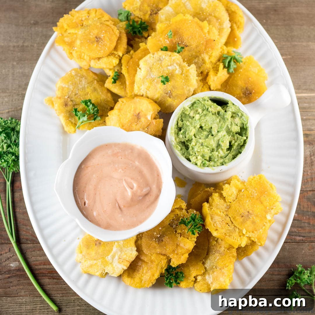 Crispy Tostones: Mastering the Twice-Fried Plantain 8 Tostones on a plate with dips.