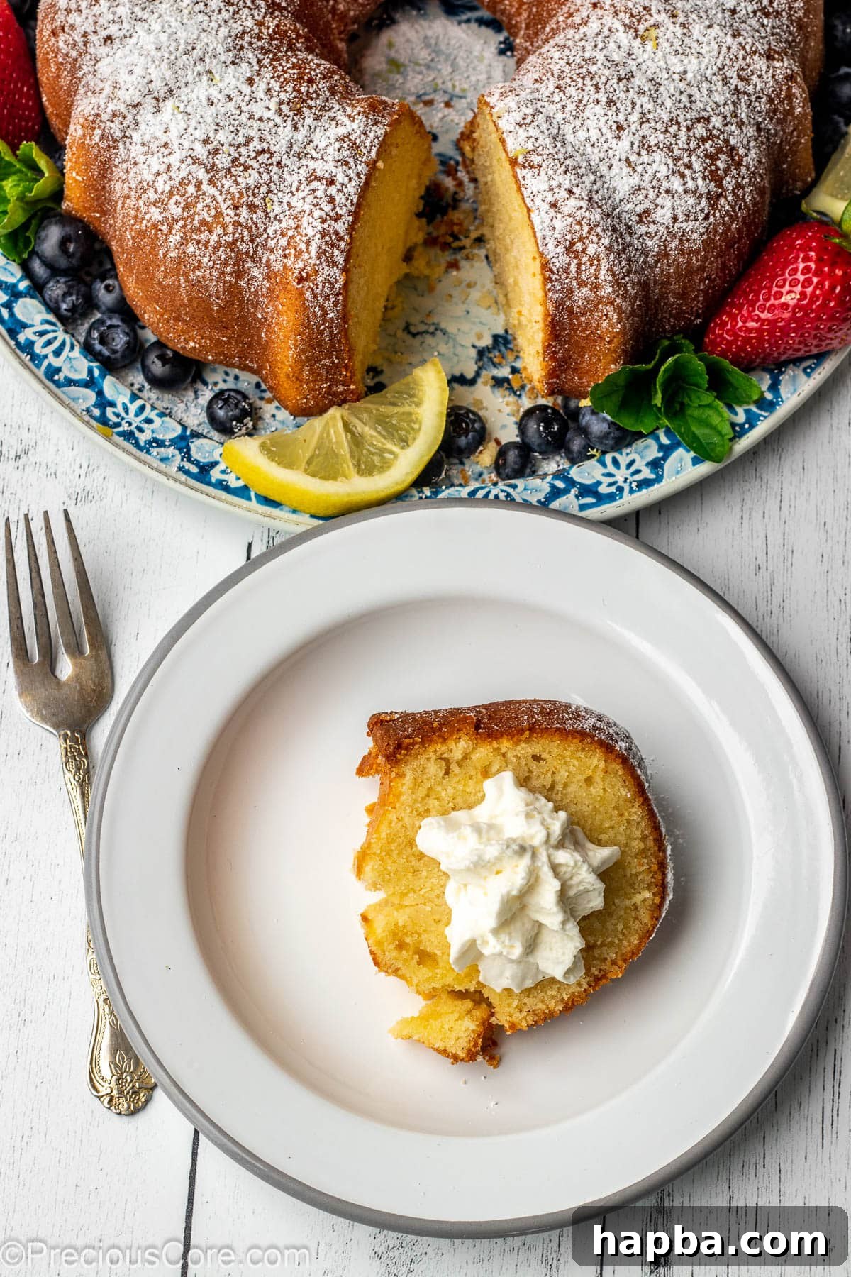 A delectable slice of lemon pound cake, beautifully topped with a generous swirl of whipped cream.